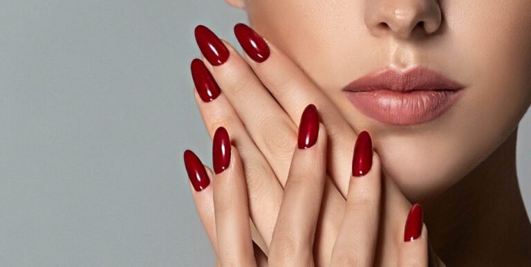 A woman with red nail polish on her face.