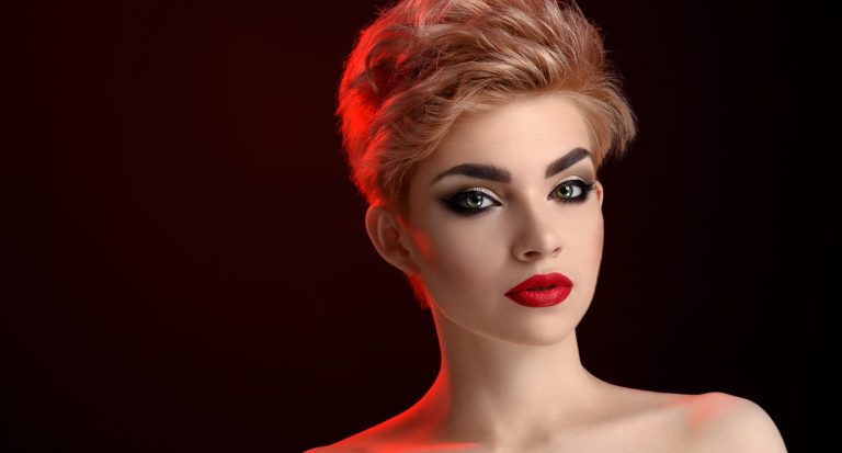 A beautiful young woman with red lips and short hair.