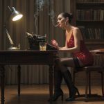 A woman in a red dress sits at a wooden desk with a typewriter, lamp, and drink in a library, smoke rising from the typewriter—a scene reminiscent of a Naomi Matthews erotic fiction author interview.